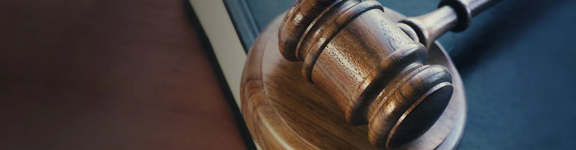 Wooden judge's gavel resting on a sound block